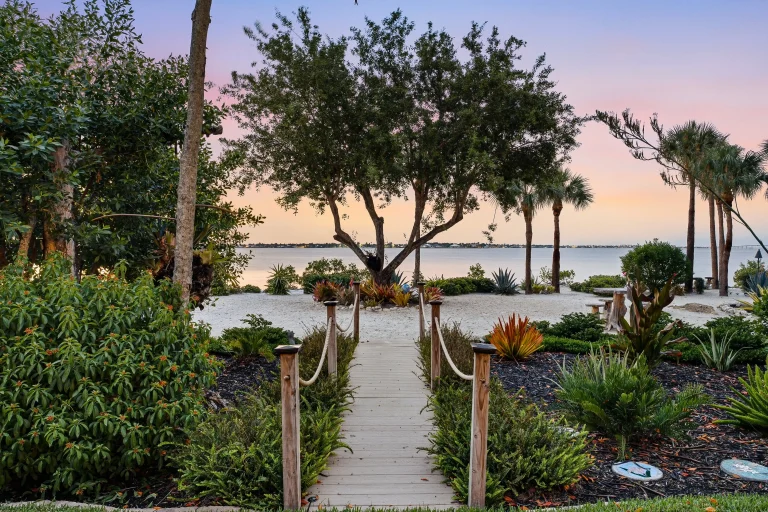 Garden path leading to the water at sunset