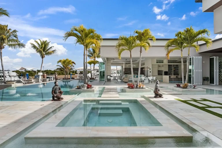 Pool and spa surrounded by palm trees at a Florida home