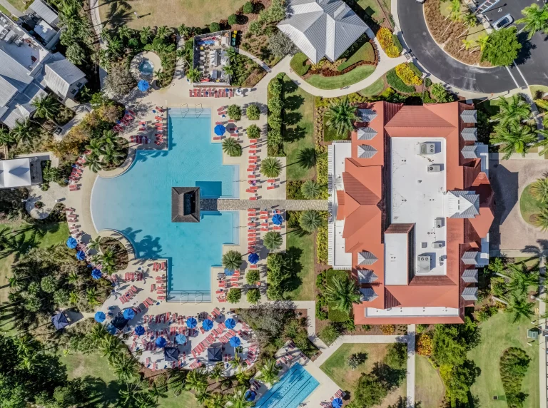 Aerial view of a resort-style pool and tile-roof home in Southwest Florida