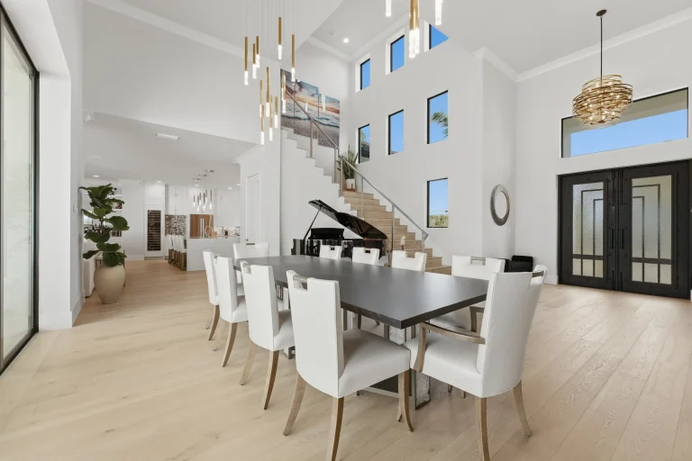 Two-story dining room with a grand piano