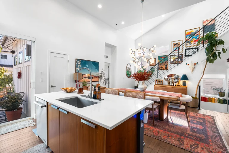 Kitchen island open to a living area with art