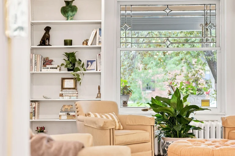 Sunroom with built-in shelves and garden views