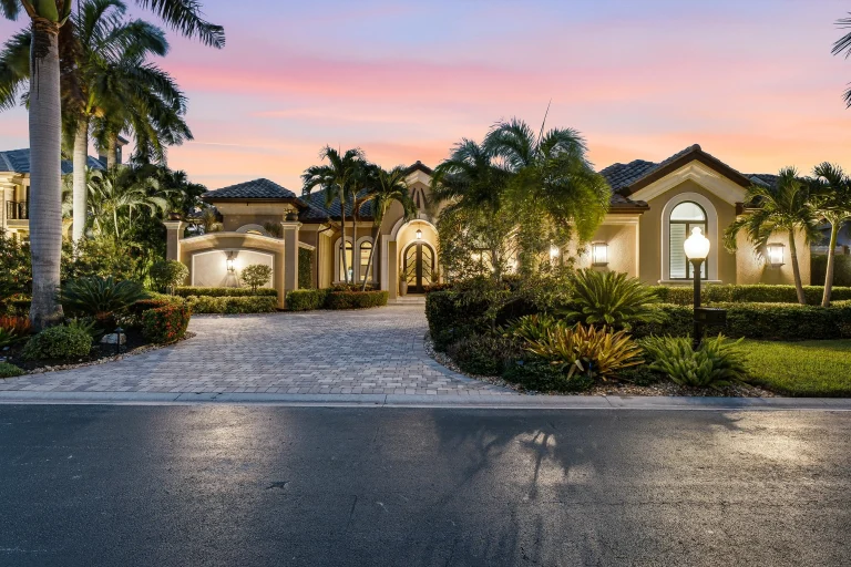 Twilight exterior of a Florida estate with circular drive