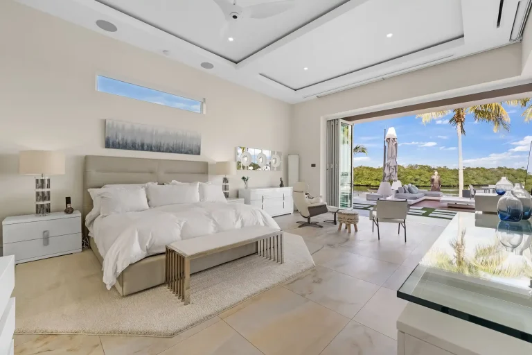 Primary bedroom with sitting area and water view