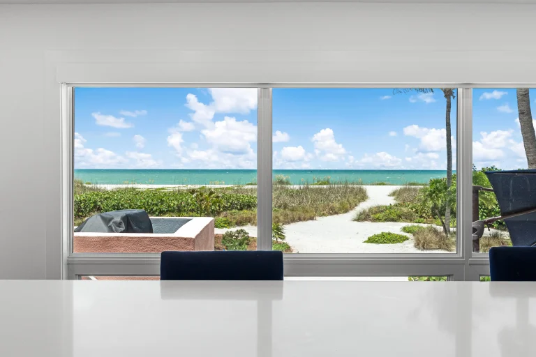 Beach view through sliding glass doors in Florida