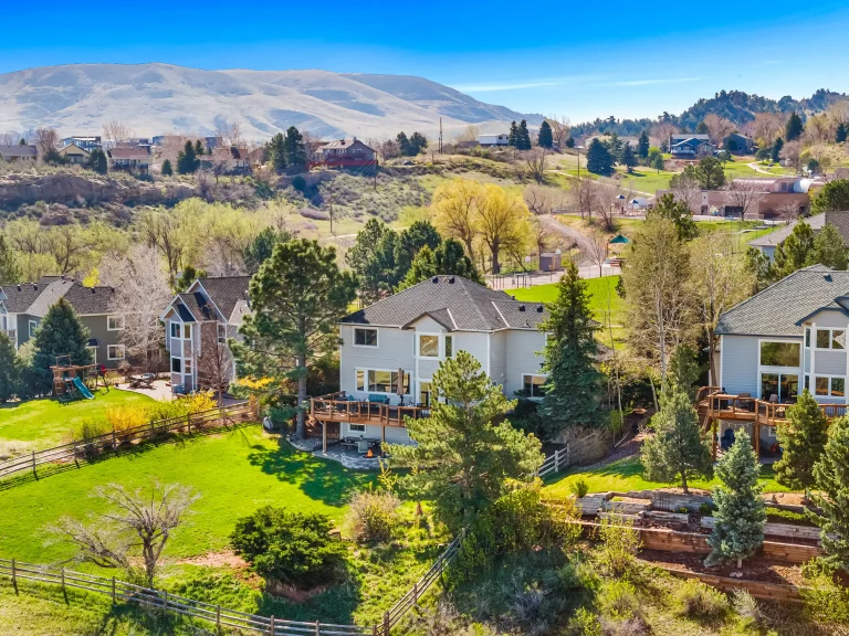 Aerial view of a Colorado neighborhood with mountains in fall color
