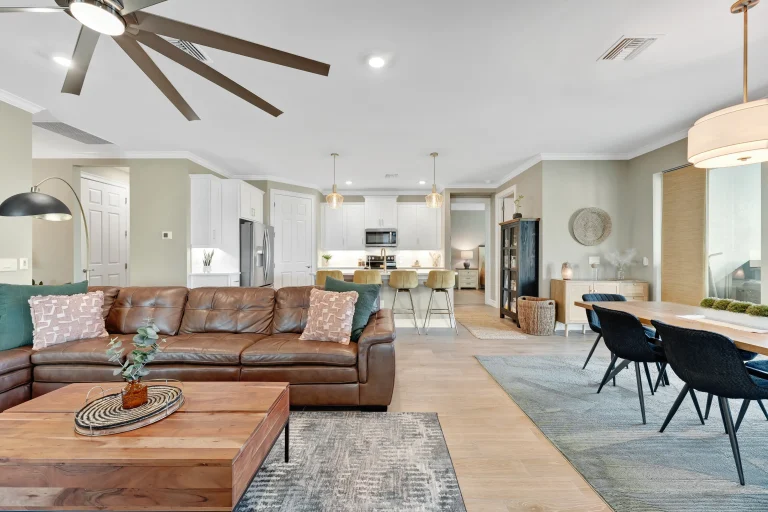 Open-concept living and dining area with ceiling fan