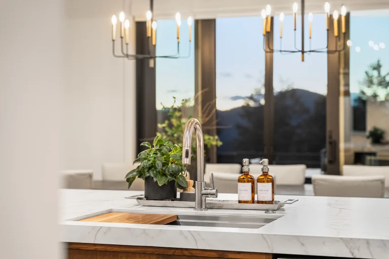 Kitchen sink with chandelier and window view