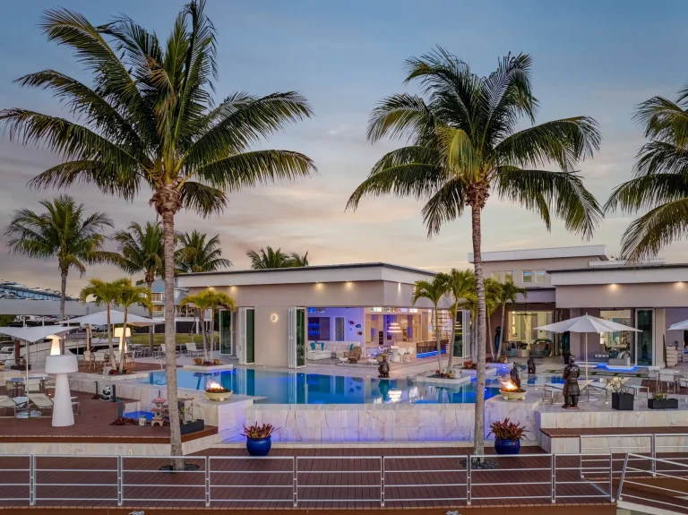 Twilight pool and patio with palm trees in Florida
