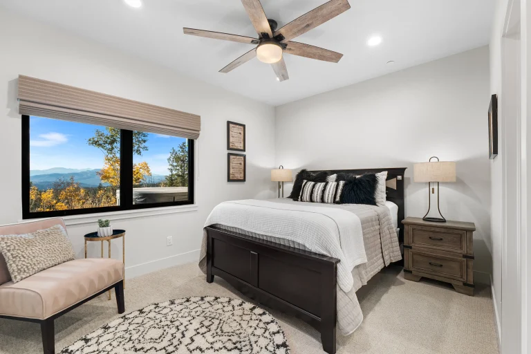 Bedroom with ceiling fan and water view