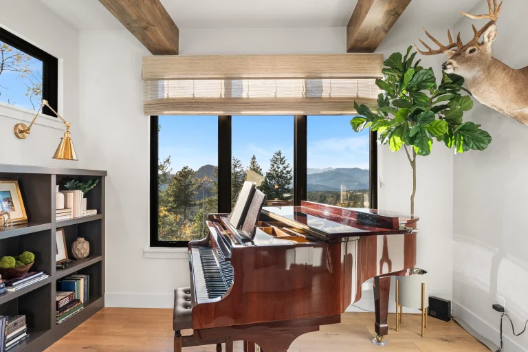 Home office with piano and built-in shelves