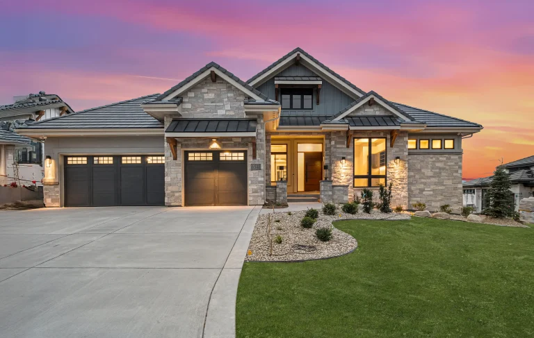 Twilight exterior of a craftsman-style home with three-car garage